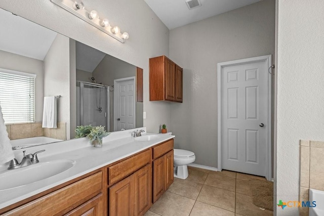 7621 Amber Meadow Loop, Temple, TX 76502 - bathroom featuring a stall shower, a bath, double vanity, tile patterned flooring, and toilet