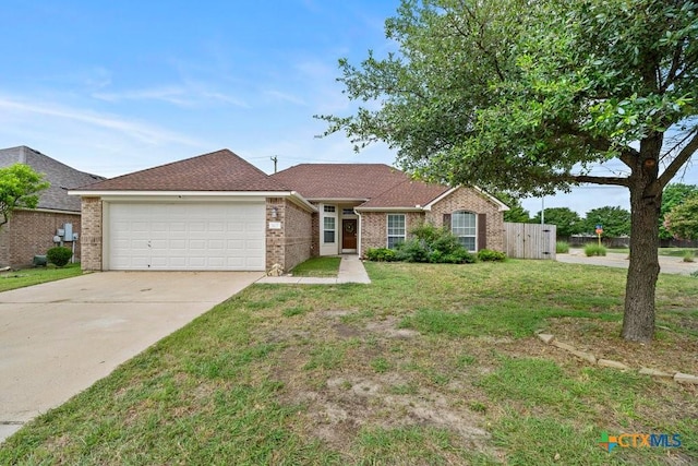 7621 Amber Meadow Loop, Temple, TX 76502 - single story home featuring an attached garage, driveway, and brick siding