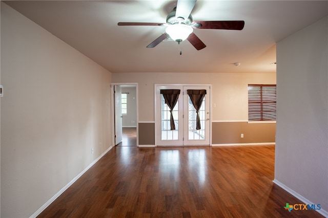 empty room featuring french doors, wood-type flooring, and ceiling fan