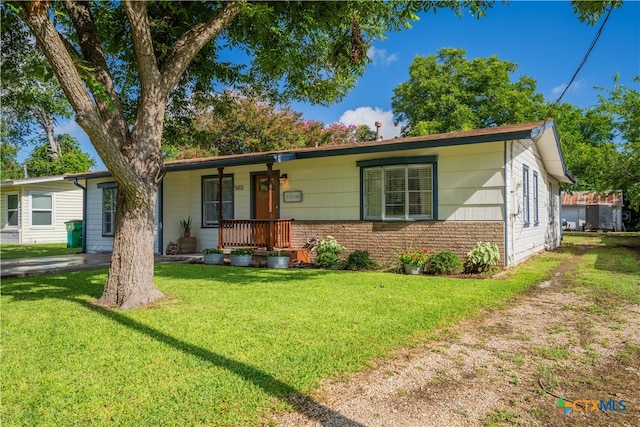 503 Maresh St, Taylor, TX 76574 - ranch-style home featuring covered porch and a front lawn