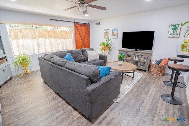 503 Maresh St, Taylor, TX 76574 - living area featuring a ceiling fan, a barn door, and light wood-type flooring