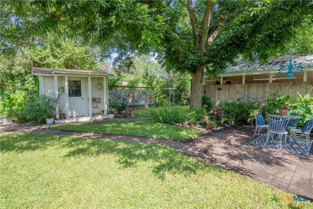 503 Maresh St, Taylor, TX 76574 - fenced backyard featuring a patio area and a storage shed