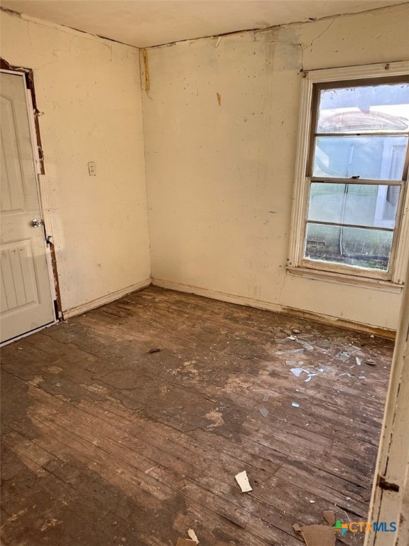 empty room with dark hardwood / wood-style flooring