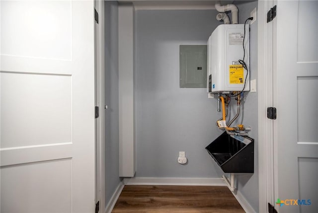 interior space with dark hardwood / wood-style flooring, electric panel, and water heater