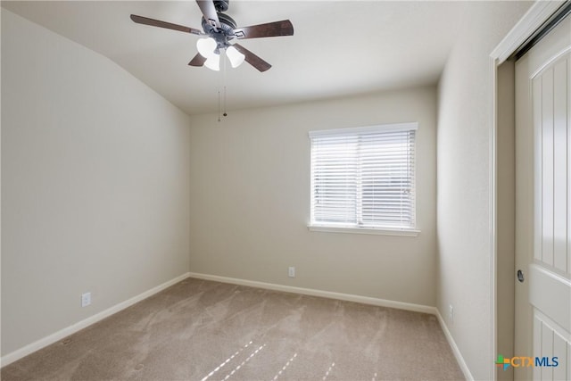 unfurnished room with light carpet, baseboards, and a ceiling fan