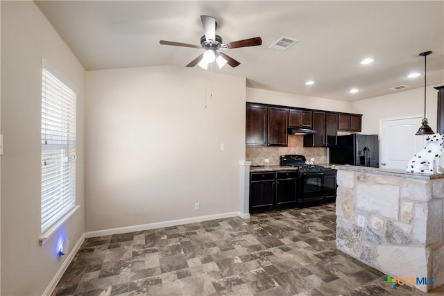 kitchen featuring light countertops, visible vents, decorative backsplash, under cabinet range hood, and black appliances