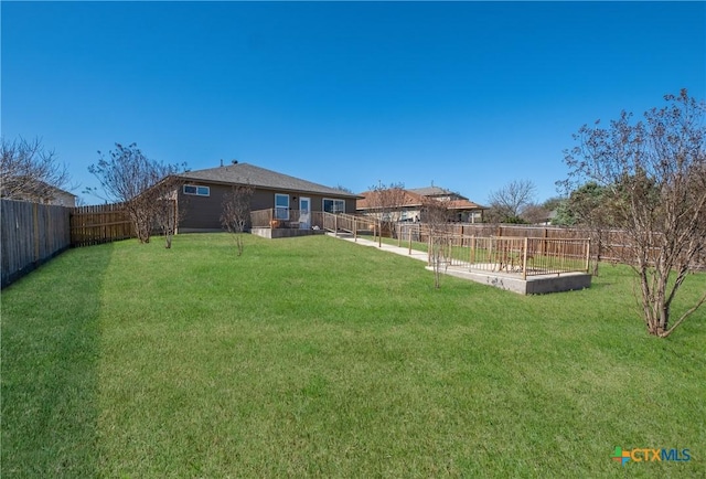 view of yard with a fenced backyard and a vegetable garden