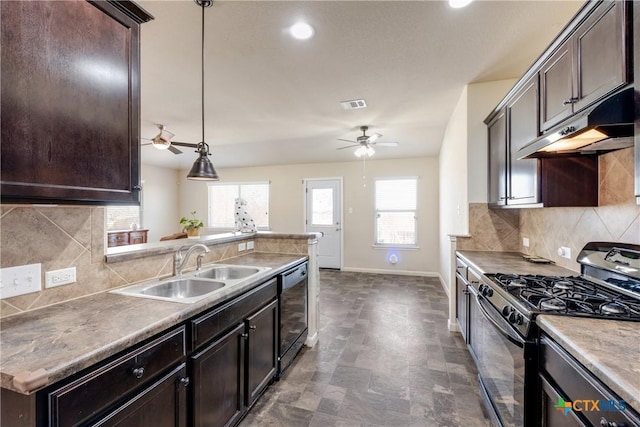 kitchen with a sink, dark brown cabinets, black gas range, and under cabinet range hood