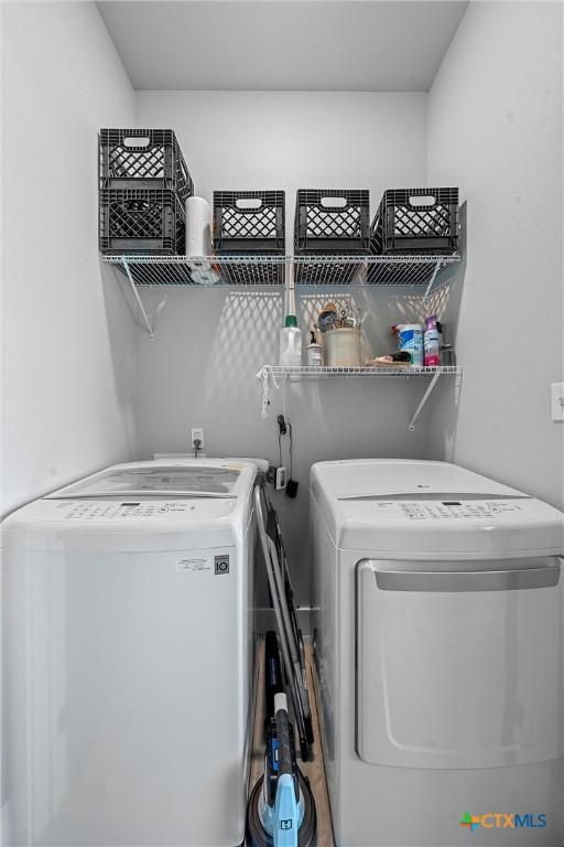 washroom featuring washer and dryer