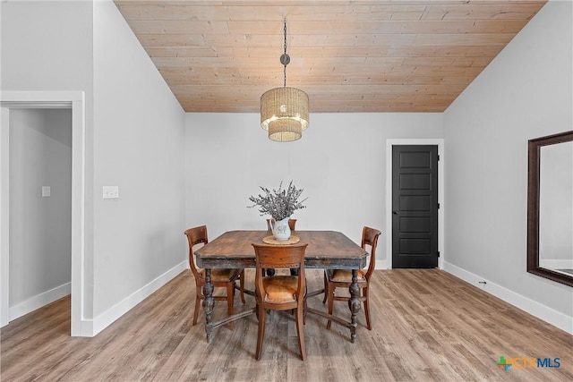 dining space featuring hardwood / wood-style floors, wood ceiling, and vaulted ceiling