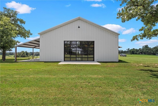 back of property featuring an outbuilding and a lawn