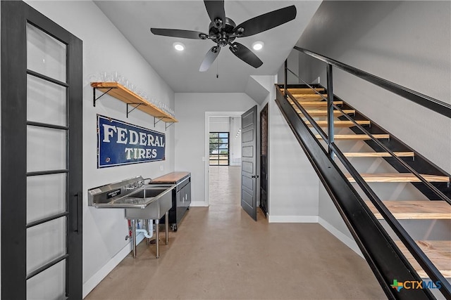 interior space with ceiling fan and concrete flooring