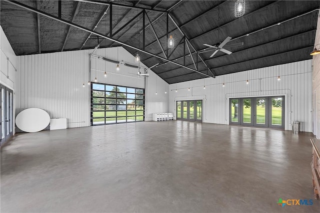 garage with ceiling fan, radiator, and wood walls