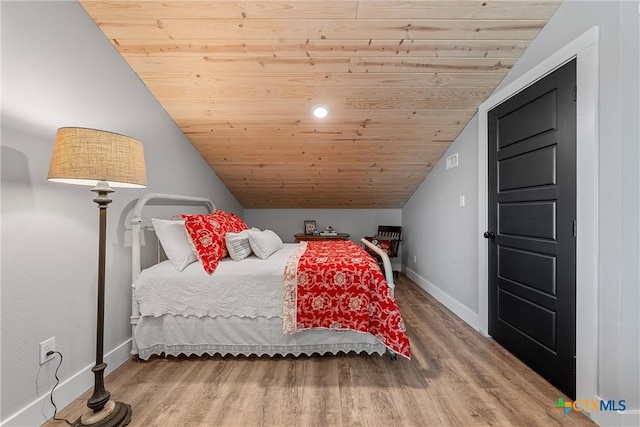 bedroom with lofted ceiling, wood ceiling, and hardwood / wood-style flooring