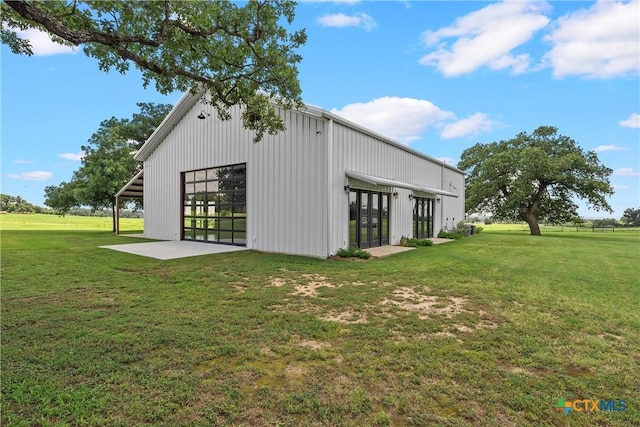 view of outbuilding featuring a lawn