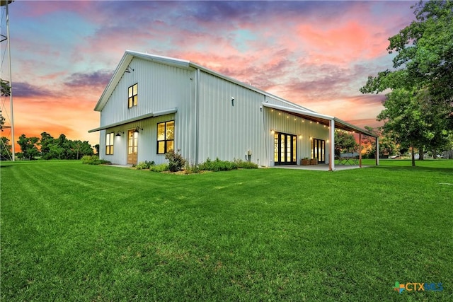 back house at dusk with a yard