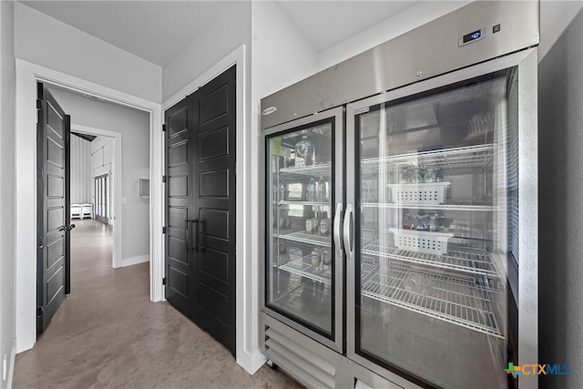 interior space featuring concrete flooring and wine cooler