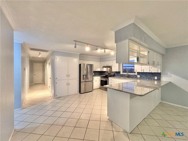 kitchen with stainless steel appliances, crown molding, light tile patterned floors, and white cabinets