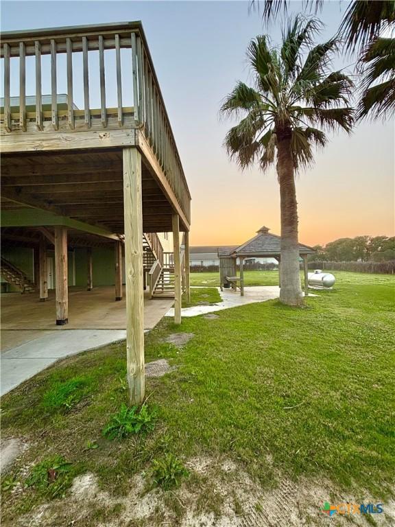 yard at dusk featuring a patio area