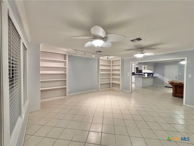 unfurnished living room with light tile patterned flooring, built in features, and crown molding