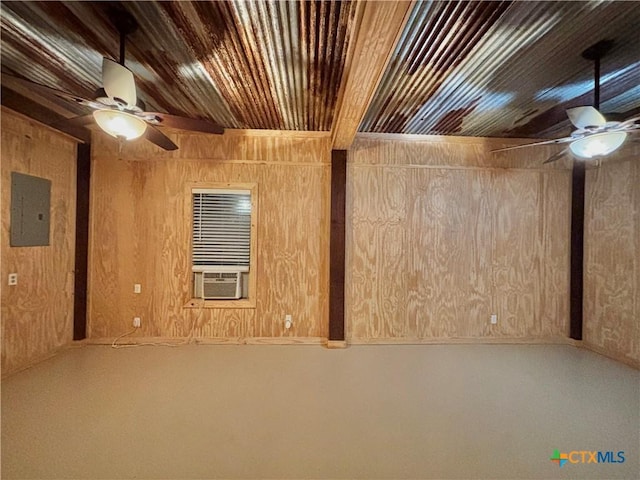 basement featuring electric panel, wooden ceiling, ceiling fan, and wood walls