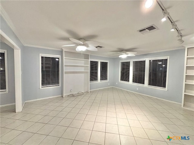 spare room with crown molding, light tile patterned floors, built in features, and ceiling fan