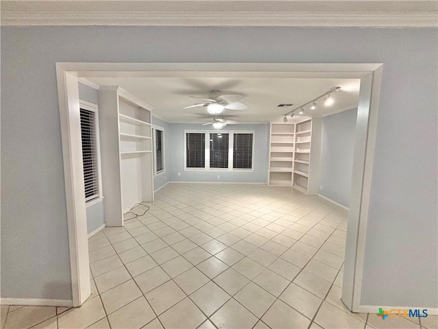 unfurnished living room featuring crown molding, light tile patterned floors, built in shelves, and ceiling fan