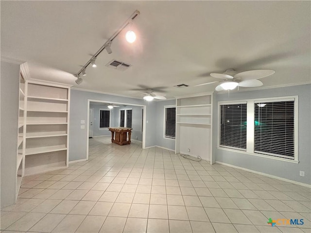 empty room featuring crown molding, light tile patterned floors, built in shelves, and ceiling fan