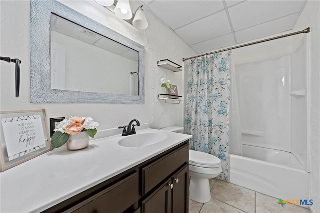 full bathroom featuring toilet, a paneled ceiling, shower / tub combo, vanity, and tile patterned flooring