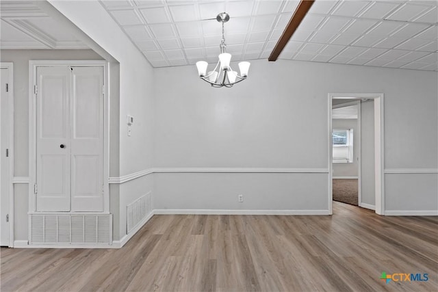 unfurnished dining area featuring light hardwood / wood-style floors and a notable chandelier