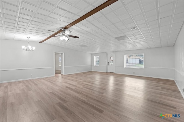 unfurnished living room with ceiling fan with notable chandelier and light wood-type flooring