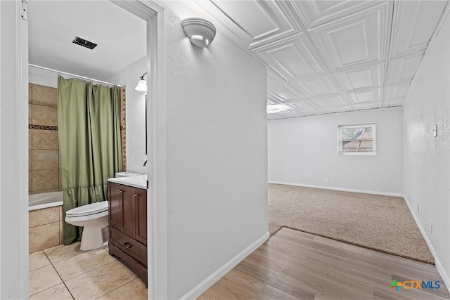 interior space with vanity, toilet, and shower / bath combo with shower curtain