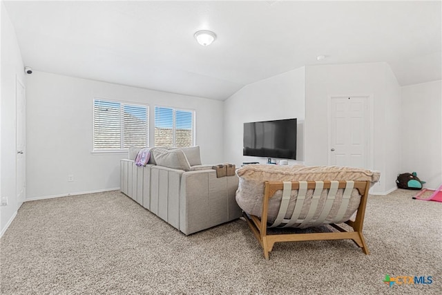 living area featuring vaulted ceiling, baseboards, and light colored carpet