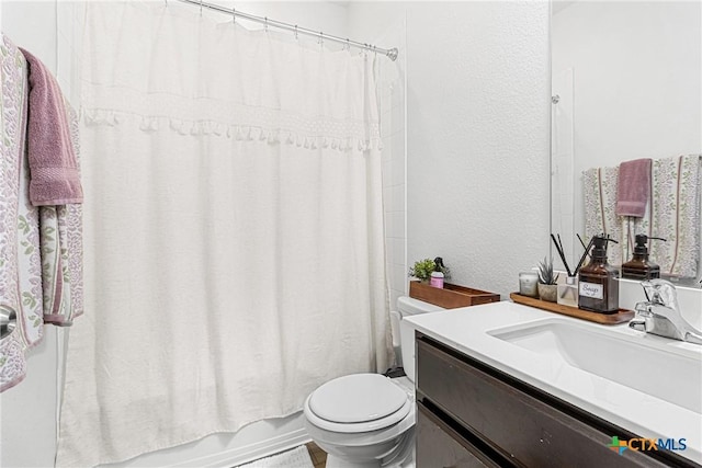 full bath featuring shower / tub combo, a textured wall, vanity, and toilet