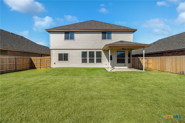 back of property with a patio, a lawn, and a fenced backyard