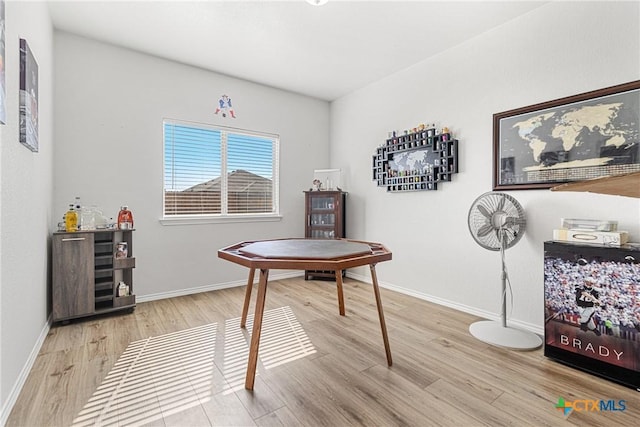 misc room with baseboards and light wood-style floors