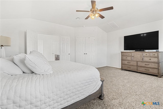 bedroom featuring visible vents, a ceiling fan, lofted ceiling, carpet floors, and a closet