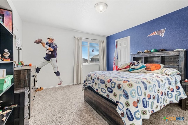 carpeted bedroom with baseboards