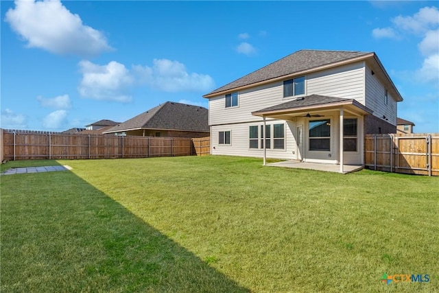 back of property with a patio area, a lawn, and a fenced backyard