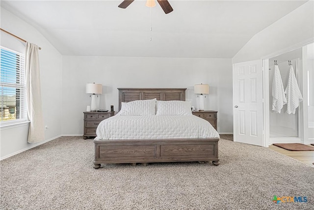 bedroom featuring lofted ceiling, baseboards, and light colored carpet