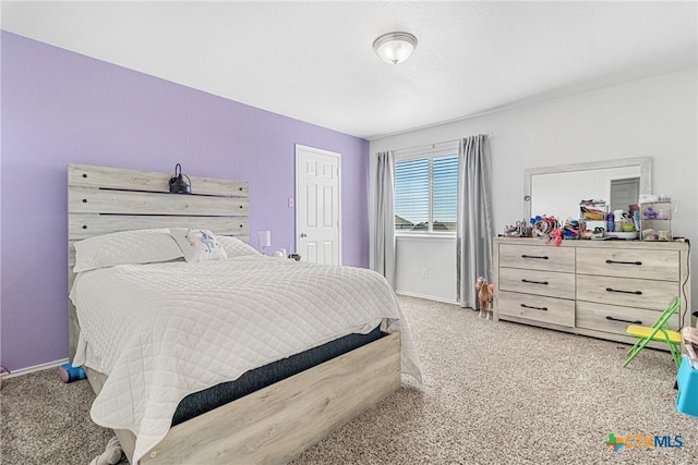 bedroom featuring carpet and baseboards