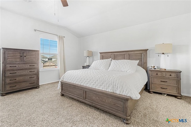 bedroom featuring lofted ceiling, light carpet, and baseboards