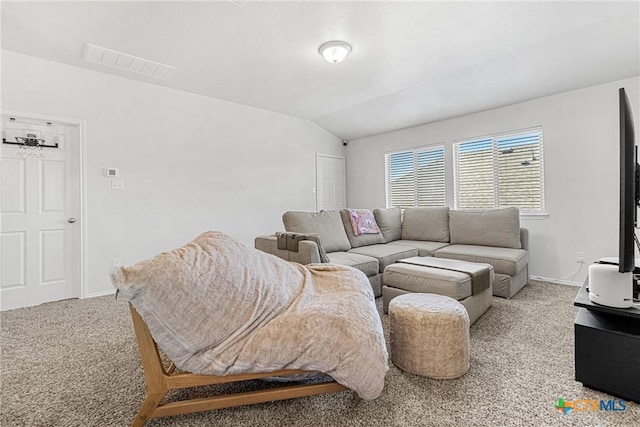 living area featuring lofted ceiling, visible vents, and carpet