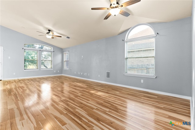 empty room featuring vaulted ceiling, ceiling fan, and light wood-type flooring