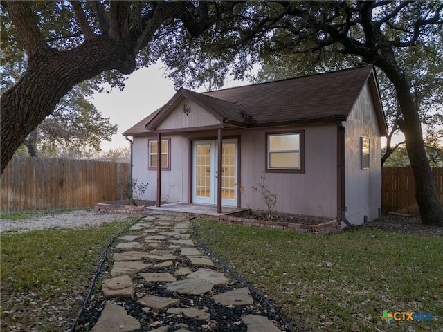 rear view of house featuring a yard