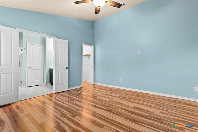 unfurnished bedroom featuring ceiling fan and light wood-type flooring