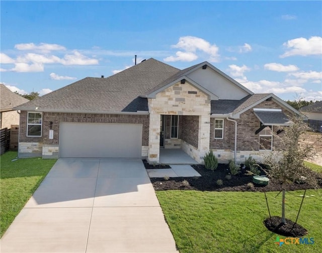 view of front of home with a front lawn and a garage