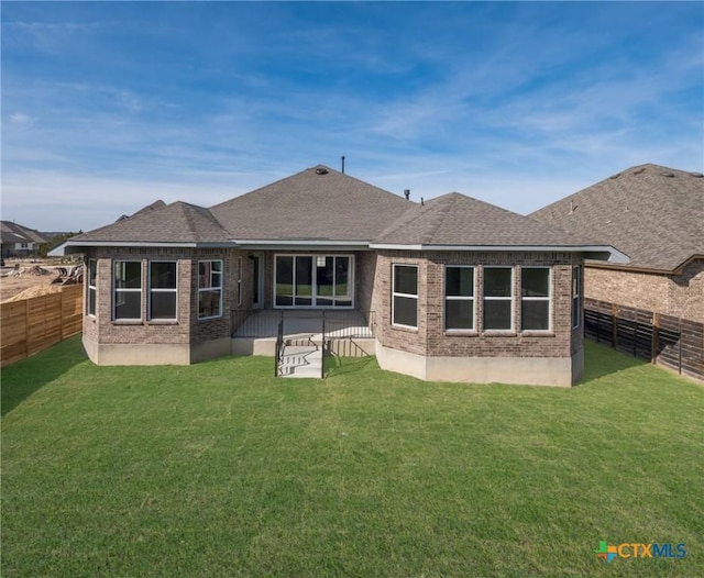 rear view of property with a lawn