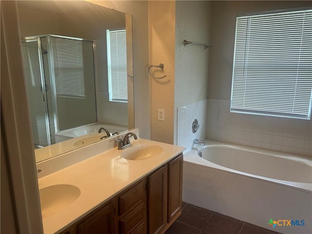 3502 Levy Ln, Killeen, TX 76542 - bathroom featuring a garden tub, a stall shower, double vanity, tile patterned flooring, and a textured wall