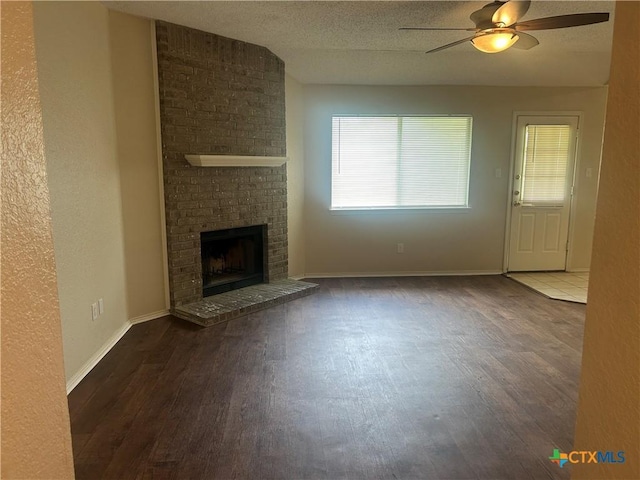 3502 Levy Ln, Killeen, TX 76542 - unfurnished living room with wood finished floors, a ceiling fan, and a brick fireplace